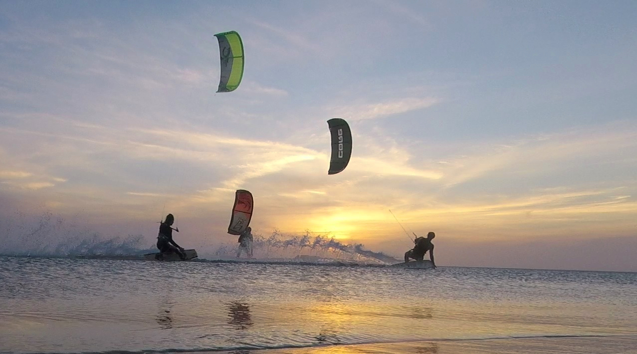 Kitesurfing in the sunset with friends